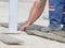 Worker marking plank for cutting