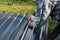 A worker marks a piece of metal sheet on grass background