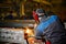 Worker with mask cuts beam with flame cutter in workshop