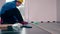 Worker master in blue work wear install the laminate floor