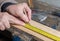 A worker measuring a board