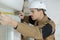 worker measuring length window frame at construction site