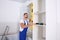 Worker measuring newly installed kitchen furniture