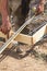 Worker Measuring Steel Rebar At Construction Site