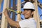 Worker Measuring Wooden Beams