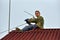 A worker mounts a individual UHF television antenna