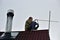 A worker mounts a individual UHF television antenna