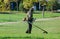 worker mowing grass with a gasoline brush. Trimmer