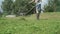 Worker mowing a grass using trimmer outdoors