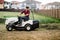 worker mowing lawn and cutting grass using powerful mower