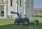 Worker mows the grass in front of the Baptistery in Pisa