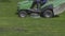 Worker mows green grass lawnmower on spring day. FHD stock footage