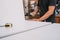 Worker nailing studs with a hammer to a piece of furniture in a workshop