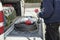 Worker near car with power extander electrical plug for construction work with red sockets in his hands