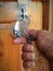Worker open unlock the door lock with holding in key in dirty hand