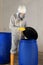 Worker opening barrel with chemical toxic waste dangerous goods