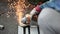 Worker operate grinding wheel.  Finishing spark blurred abstract bokeh background.