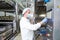 Worker operates forming machine at cheese food production factory