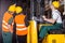 Worker operating forklift in warehouse