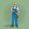 Worker in overalls and helmet with a screwdriver.