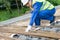 Worker in overalls takes iron rods for construction, close-up