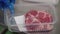 Worker packing chopped meat in a meat factory