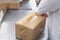 Worker packs boxes with products in a factory, industry