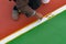 Worker painting the sideline on the floor for outdoor stadium