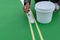 Worker painting the sideline on the floor for outdoor stadium