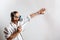 Worker painting wall with spray gun in white color.