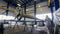 Worker paints large pipe with sprayer in workshop timelapse