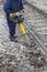 Worker perform maintenance of way on railroad