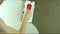 A worker plasters the wall with a spatula and applies a cement mix solution. The repairman lays the plaster on the drywall.