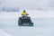 a worker plows heavy white snow during a Michigan winter