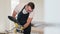 A worker polishes a pine board with a grinding tool. A man holds a power tool for grinding and polishing the surface of board