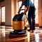 Worker polishing floor with polishing machine, maintenance janitorial work on building