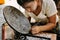 A worker polishing a lacquerware dish in Bagan.