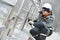 Worker polishing metal fence barrier