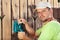 Worker polishing old wooden fence