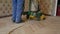 Worker polishing old wooden parquet floor
