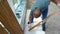 Worker polishing wooden plank with lacquer. Guy polish wood board