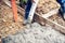 Worker pouring cement and concrete with pump tube on reinforcement steel bars