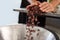 Worker pouring cocoa beans into a bowl for chocolate production