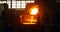 Worker pouring molten metal from container in foundry workshop 4k