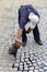 Worker pouring molten pitch from a tar bucket