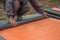 Worker preparing insulation material for basement wall 3