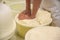 Worker pressing curd into mould at cheese factory