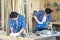 Worker or Professional constructor repair in wood working. Carpenter working with belt grinding machine