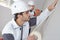 Worker protecting wall with masking tape before painting