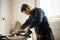 Worker in protective clothes working in workshop